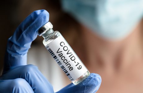 female doctor holds coronavirus vaccine vial
