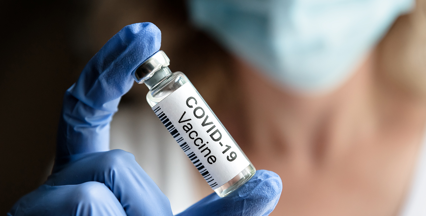 female doctor holds coronavirus vaccine vial